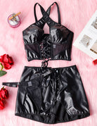 Black PU lingerie set flat lay: halter top with lace-up front and mini skirt