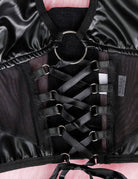 Close-up of black halter lingerie top with ring clasp and lace-up strap front