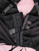 Close-up of black bra back with adjustable hook-and-eye band and sheer mesh panels