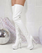 White patent over-the-knee platform stiletto boots with sleek, glossy finish and pointed toe.