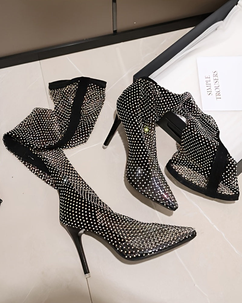 Black rhinestone fishnet over-the-knee stiletto boots, pair on display
