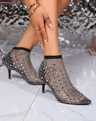 Black rhinestone fishnet mesh booties with pointed toe and kitten heel, close-up