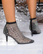 Black rhinestone fishnet mesh booties with pointed toe and kitten heel, heel view