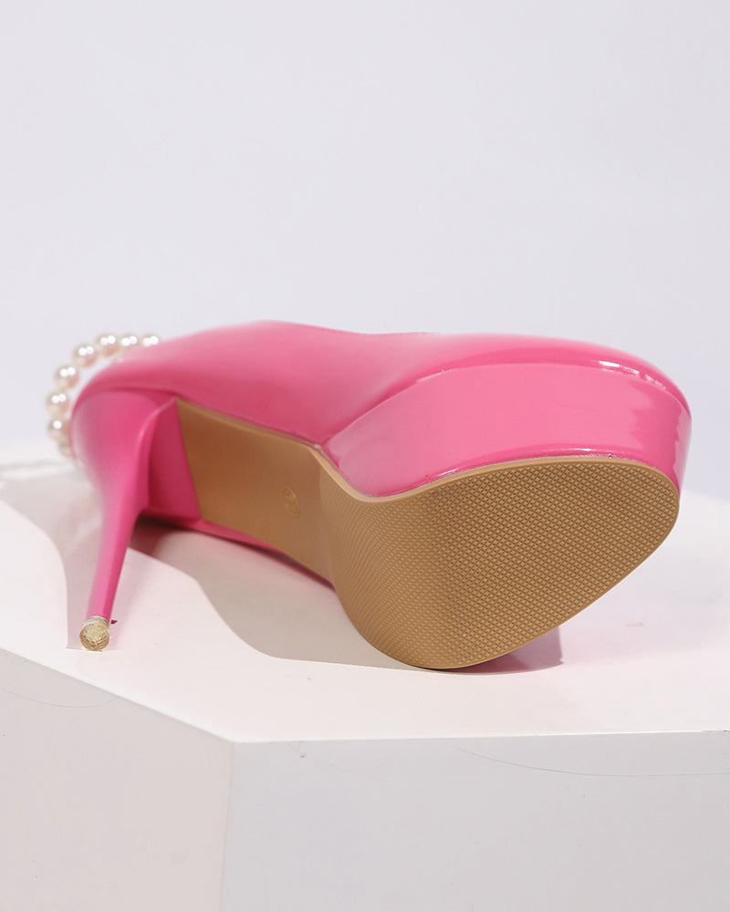 Pink patent platform pump heel with pearl anklet chain detail
