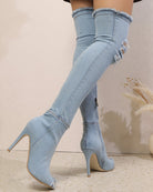 Light blue distressed denim over-the-knee stiletto boots, side view