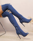 Dark blue distressed denim over-the-knee stiletto boots with peep-toe cutouts