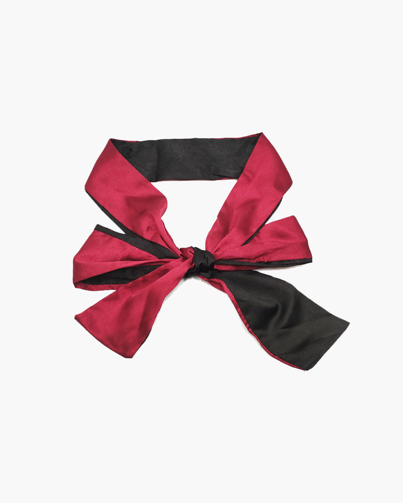 Adjustable satin eye mask in red and black, ideal for meditation, travel, or romantic use