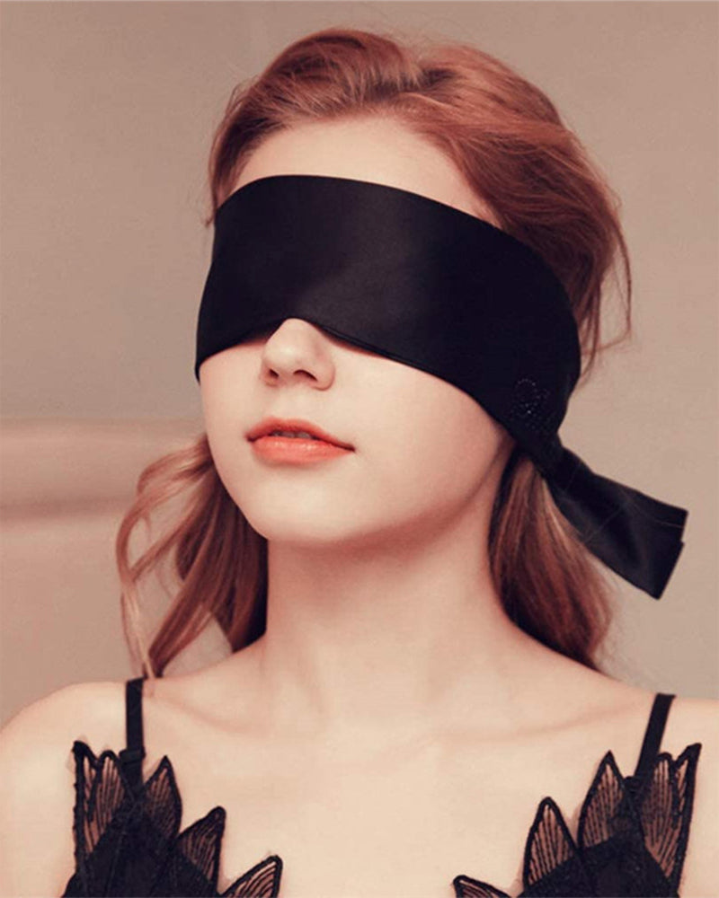 Black satin eye mask, perfect for meditation or romantic use. Adjustable, comfortable design.