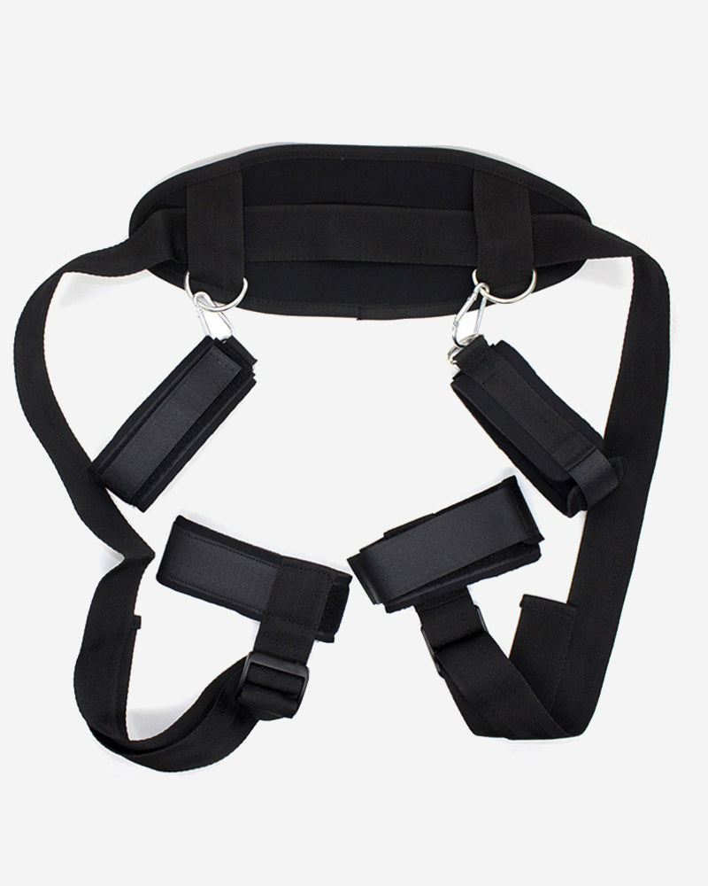 Black adjustable restraint set with body harness, wrist and ankle cuffs for intimate play