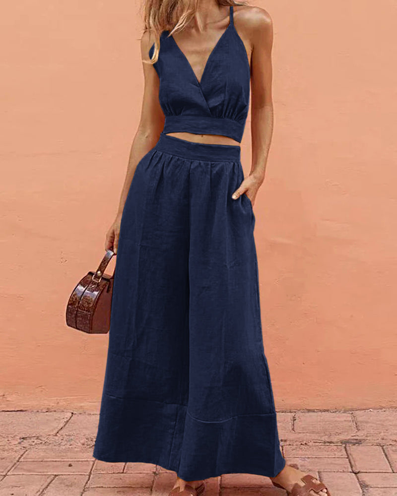 Navy blue two-piece set: crop top and wide-leg pants. Vacation style, navy blue outfit for leisure.
