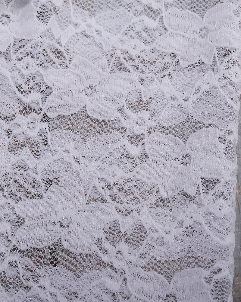 White lace fabric detail for see-through blouse set, showcasing floral patterns and soft texture