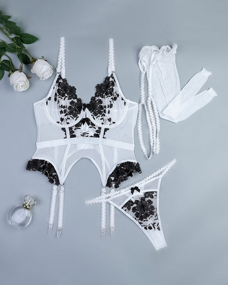 Embroidered white corset set with black lace, stockings, and thong. Sweet and seductive lingerie.