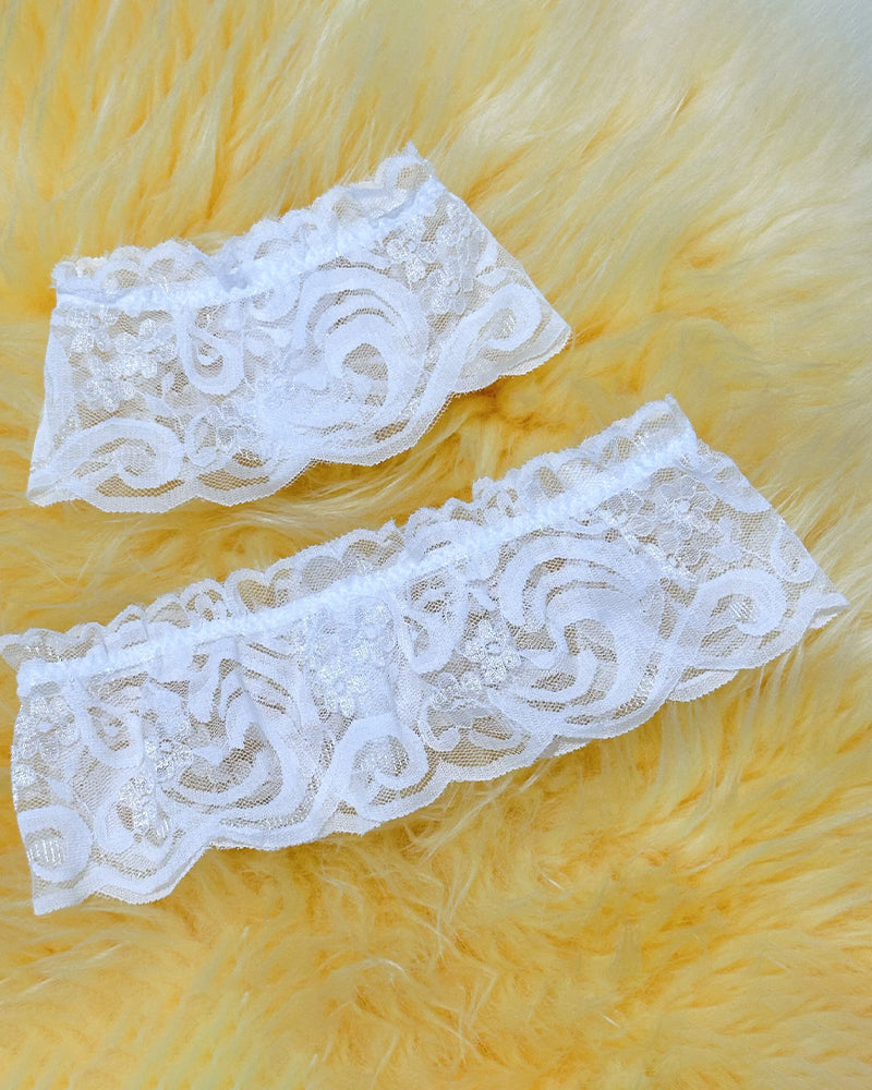 Maid Costume white lace garter set with floral design on yellow background.