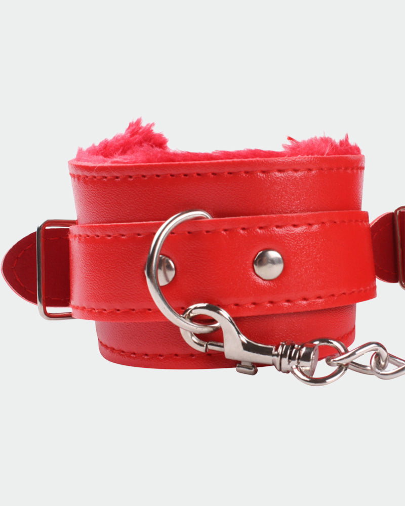 Red leather wrist cuffs with plush interior and silver hardware for intimate role play