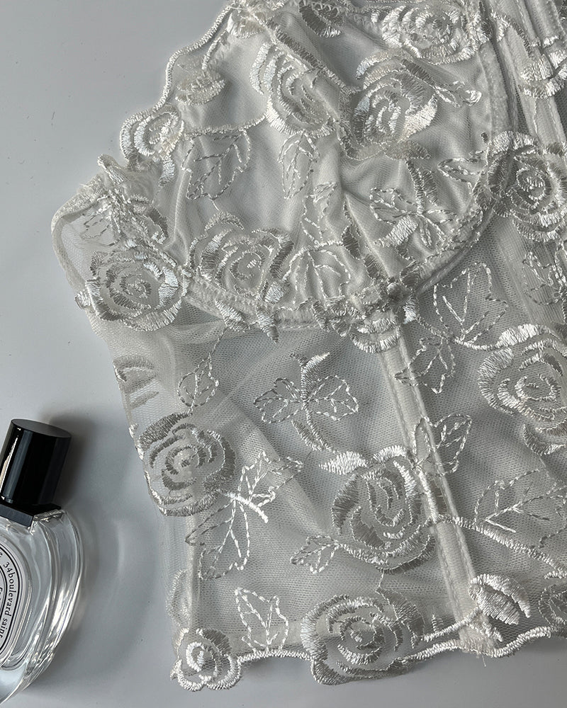 White floral strapless mesh bustier with rose embroidery and boning for elegant support.