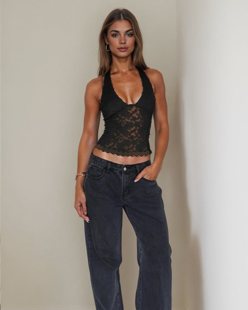 Black halter lace crop top with plunging neckline and dark wash jeans. Sexy going-out outfit.