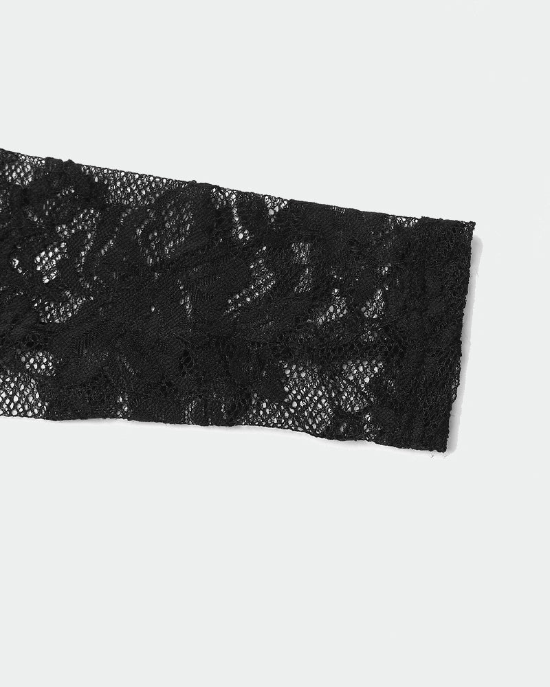 Black floral lace long sleeve detail. Sheer bodysuit fabric, showcasing texture and design.