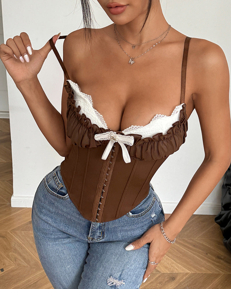 Brown corset top with lace trim, ruffled details, and adjustable straps, paired with blue jeans