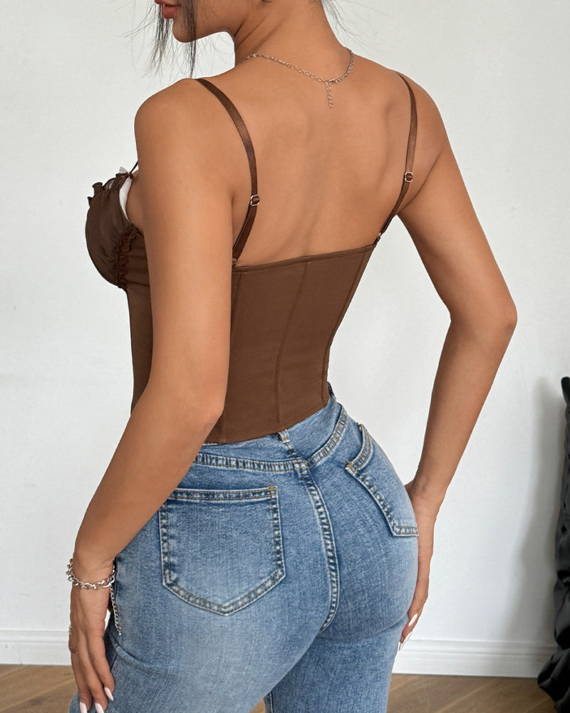 Brown corset top with lace trim and adjustable straps, paired with blue jeans, highlighting curves