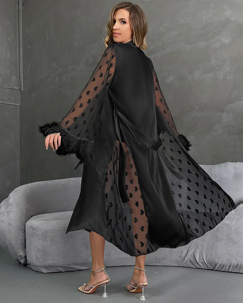 Black satin nightgown with heart sleeves and feather trim, perfect for a sensual look