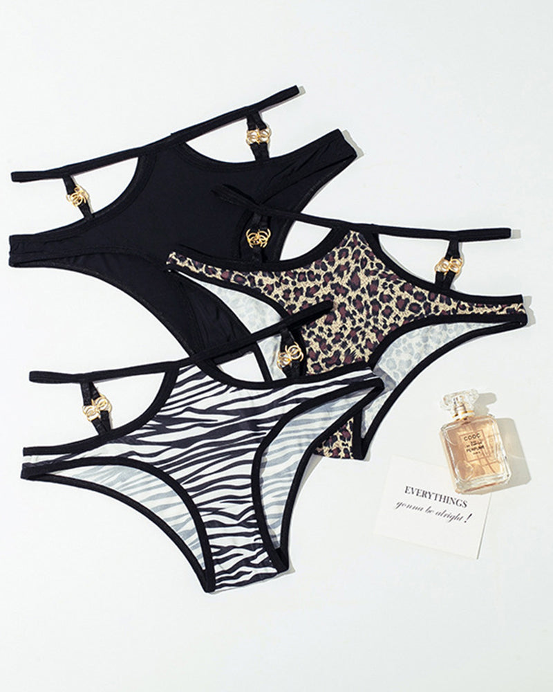 Animal print panties: black, leopard, zebra. Gold accents, mid-waist design. Sexy lingerie.
