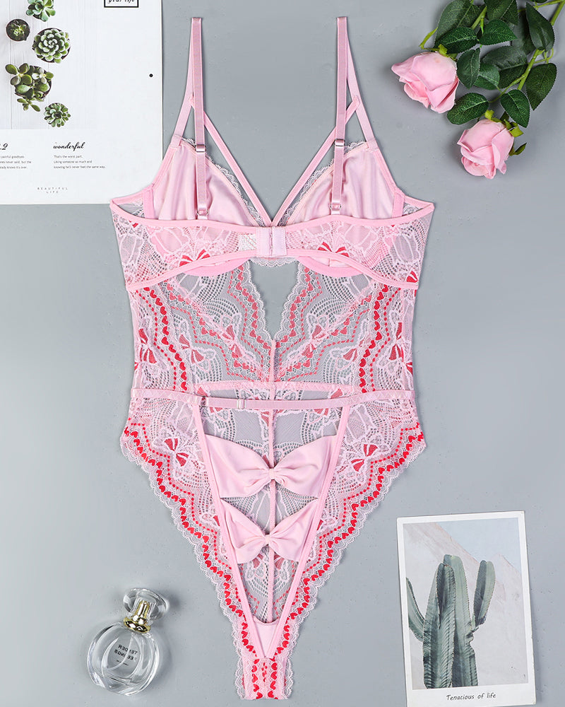 Pink lace bodysuit with bow cutout design and suspender straps. Sexy lingerie for women.