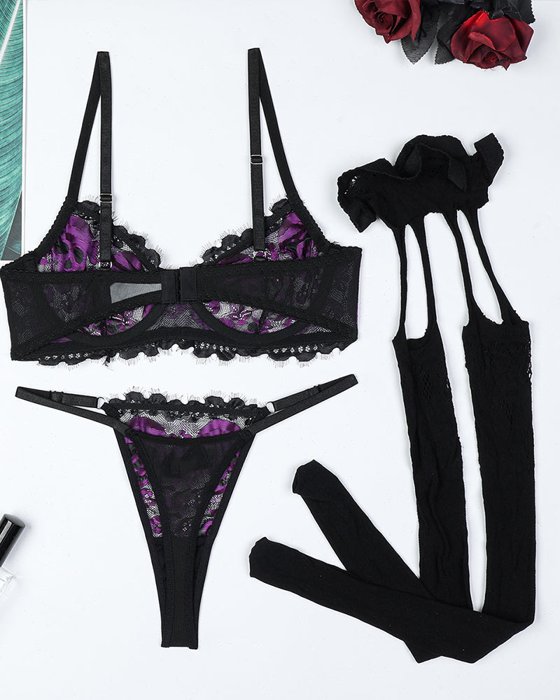 Black skull lace bra set with purple accents, stockings and garter belt, perfect for a sexy look.