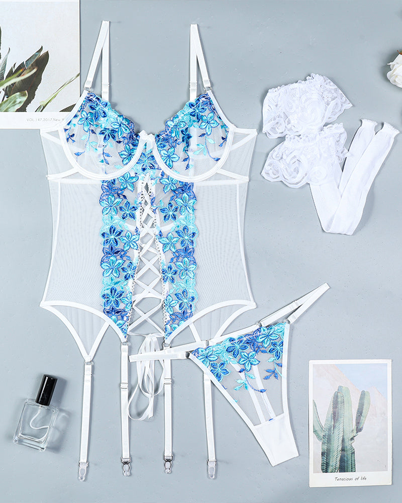 Blue floral embroidered lingerie set with white fishnet stockings, a sexy and elegant look.