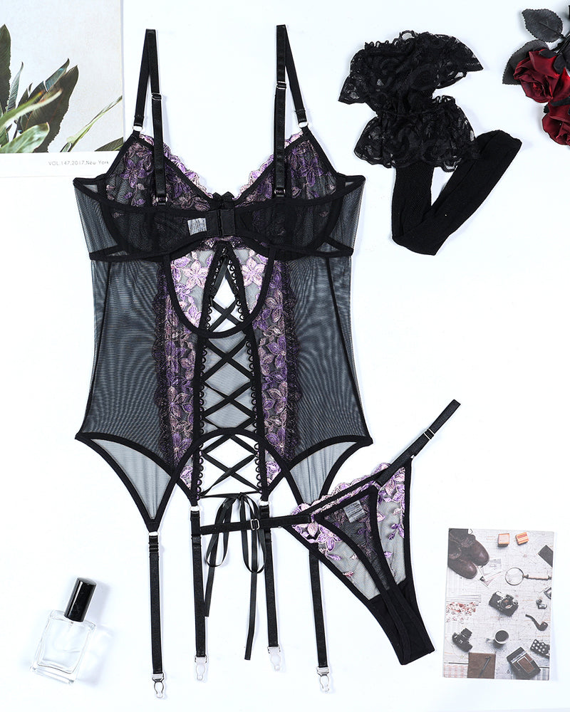 Black floral embroidered lingerie set with purple accents and fishnet stockings