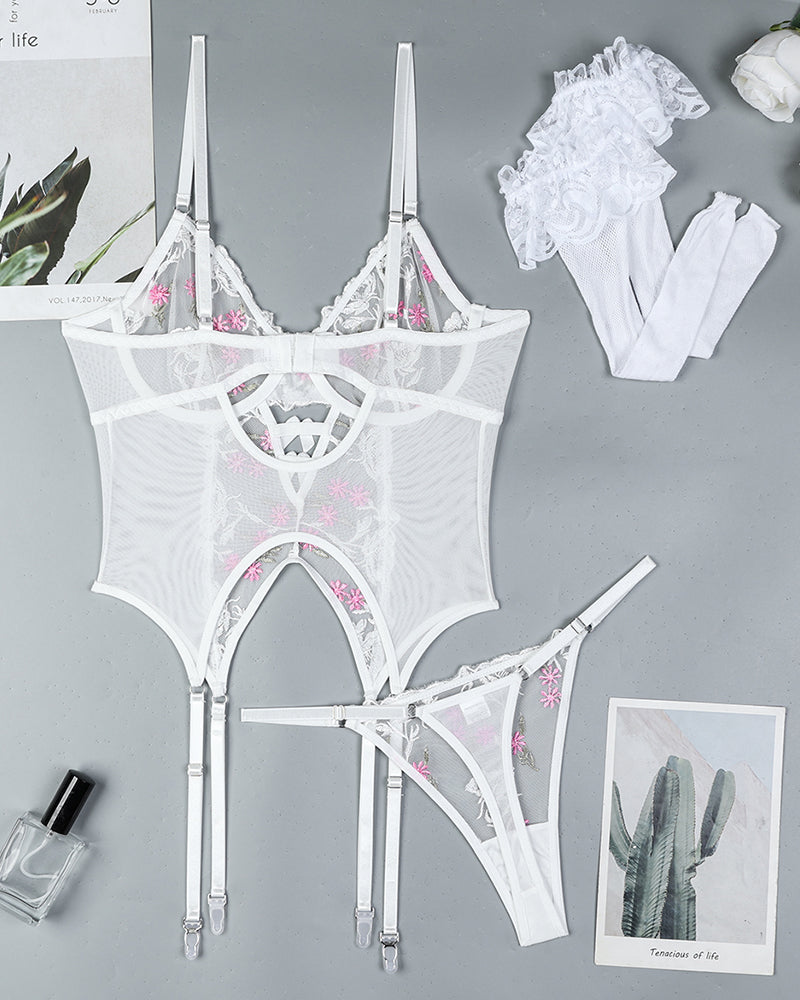 White floral embroidered lingerie set with garter straps and stockings. Sexy sheer design.