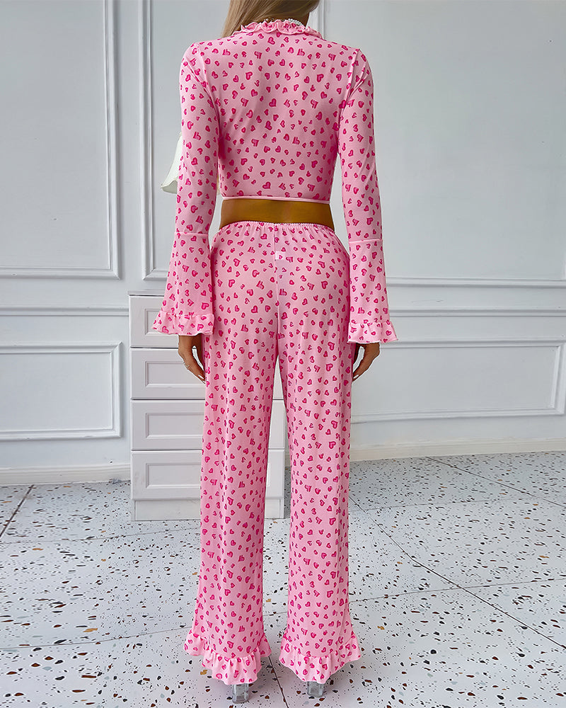 Pink heart print pajama set with ruffled top and pants, comfortable sleepwear