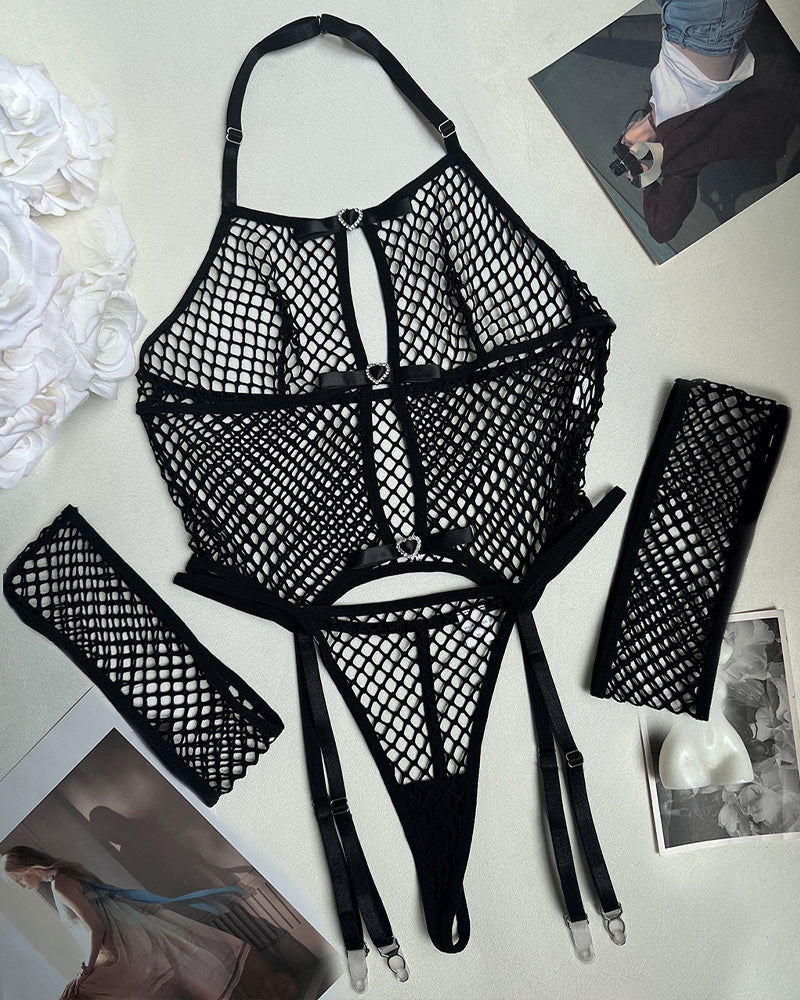 Black fishnet halter lingerie set with heart accents, garter belt, and arm cuffs. Sexy lingerie.