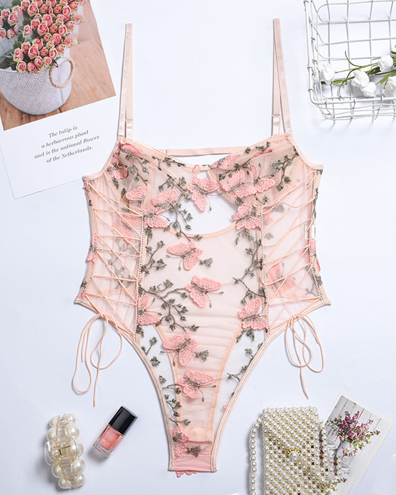 Butterfly embroidered lace bodysuit in blush pink, featuring adjustable straps and lace-up details.