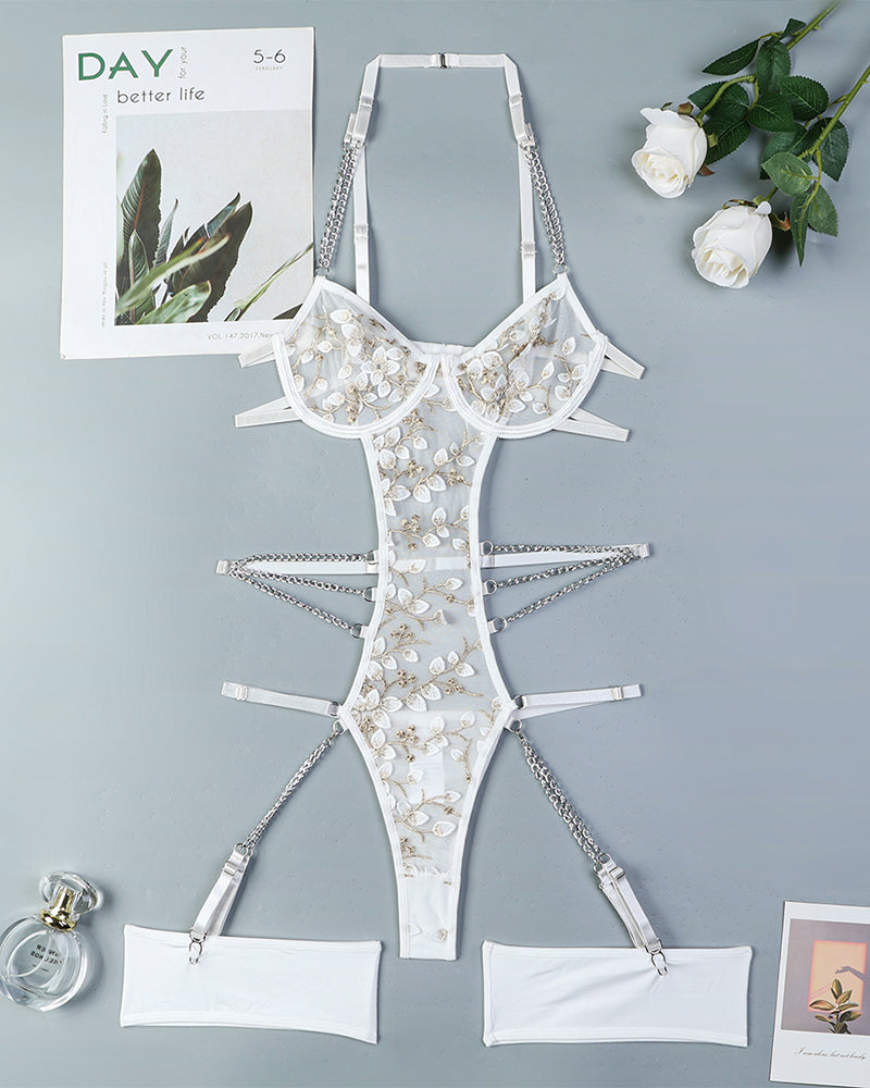 White lace bodysuit with chain details and floral embroidery, perfect for a confident look.