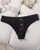 Denim thong low-rise panties in black, flat lay with two gold buttons