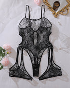 Black sheer floral lace teddy bodysuit with bow at front, open sides, and adjustable straps