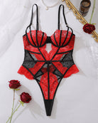Red and black lace corset bodysuit on flat lay, plunge cups, mesh panels, strappy back
