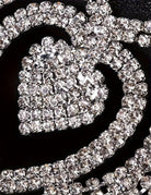 Rhinestone heart pendant and crystal chain detail on a black waist accessory