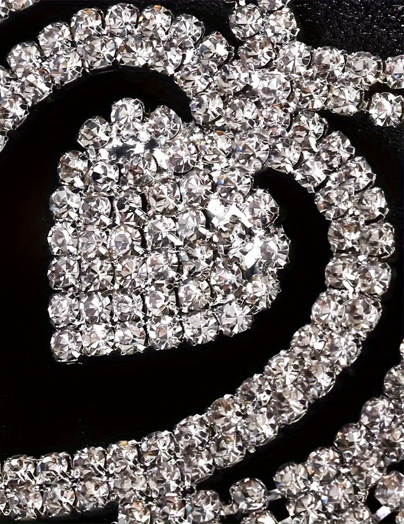 Rhinestone heart pendant and crystal chain detail on a black waist accessory