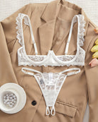 Cupless lace bra and crotchless thong set in white lace with scalloped ruffle straps