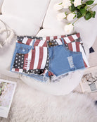 High-waisted distressed denim shorts, American flag patchwork with front pocket detail