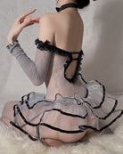 Back of grey sheer mesh babydoll with black cutout trim and ruffled skirt