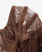 Brown lace bodysuit fabric close-up with ruffled tutu trim