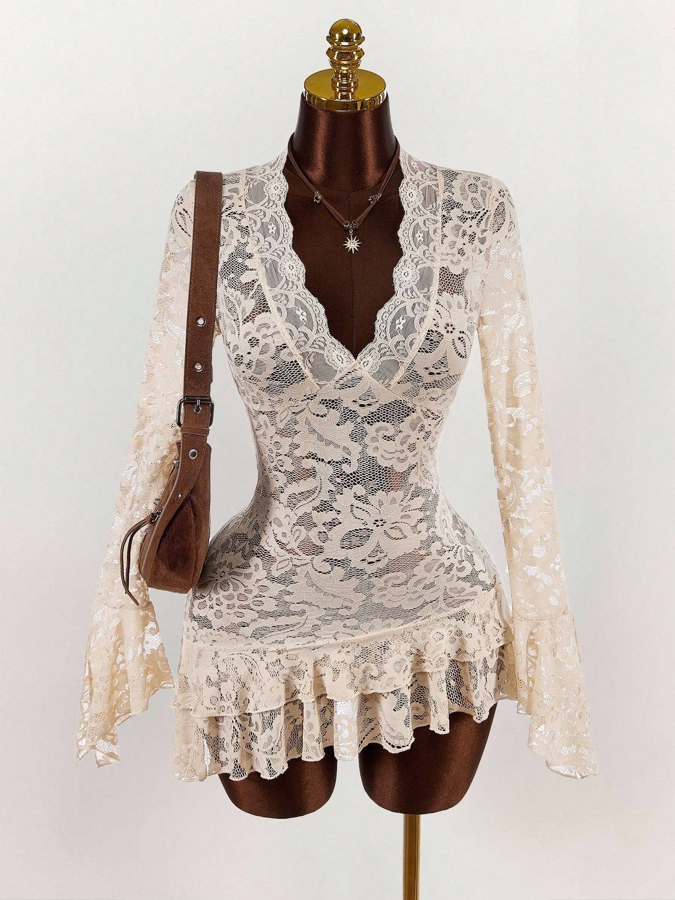 Cream lace mini dress with V neckline, long sleeves, and ruffled tiered skirt