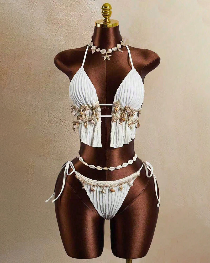 White pleated halter bikini set with shell-and-starfish accents, tie-side bottoms