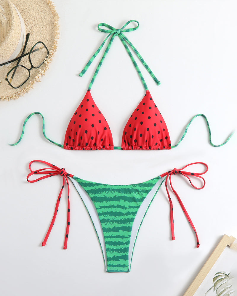 Bikini set flat lay: red polka-dot triangle top and green striped side-tie bottoms