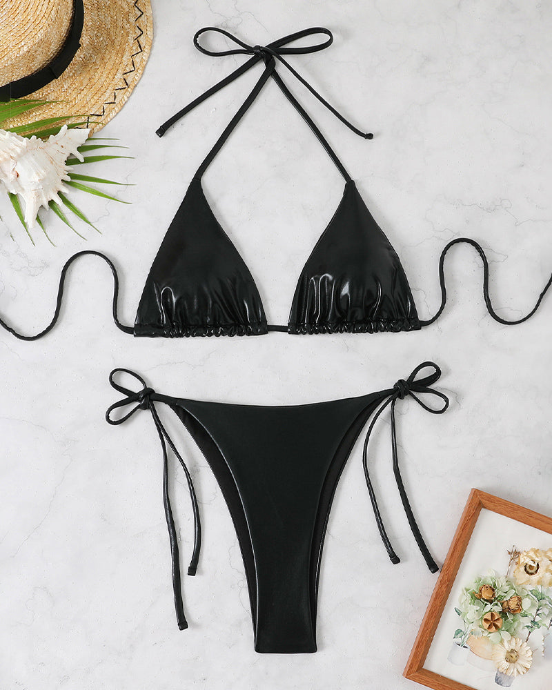 Black shiny triangle halter bikini top and side-tie thong bottoms, flat
