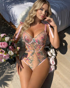 Pink sheer bodysuit with floral embroidery, plunge underwire and ribbon tie details