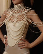 Pearl fringe halter top with layered pearl body chain and fringe drape at upper torso