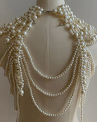 Pearl fringe halter top with layered pearl body chain, pearl strands and clasp at collar